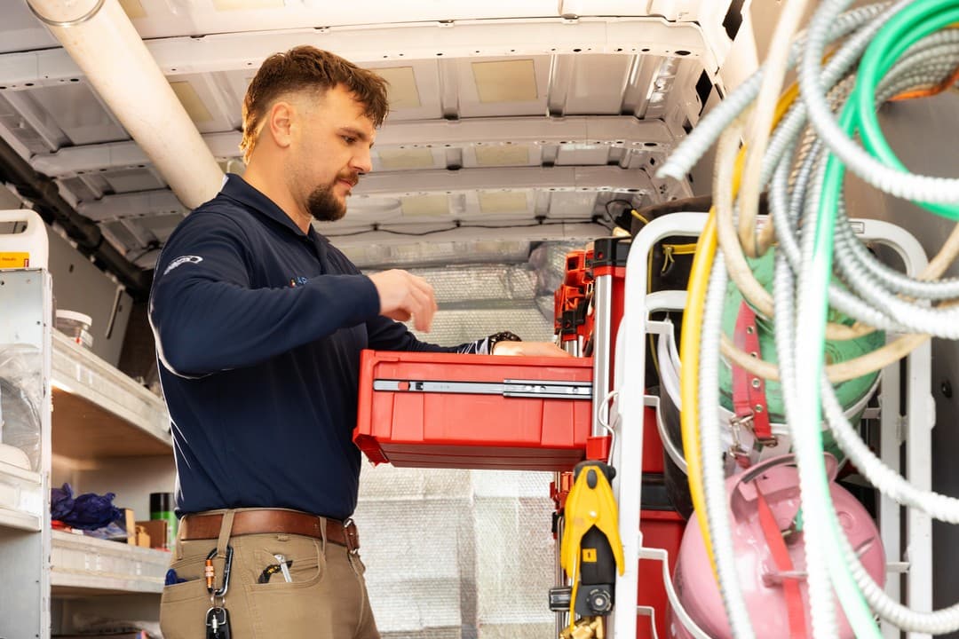 Technician preparing tools in service van