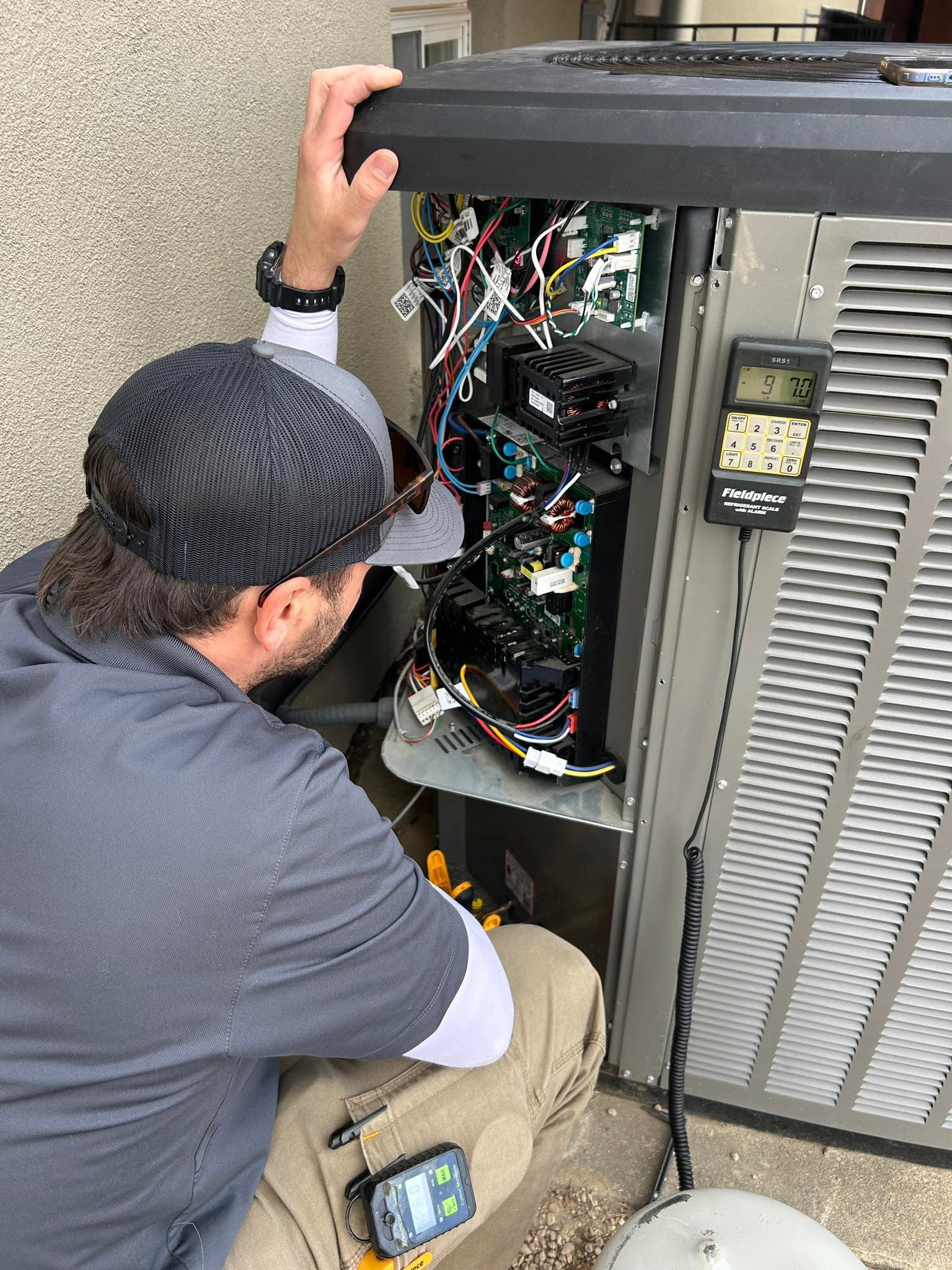 Technician diagnosing HVAC control panel